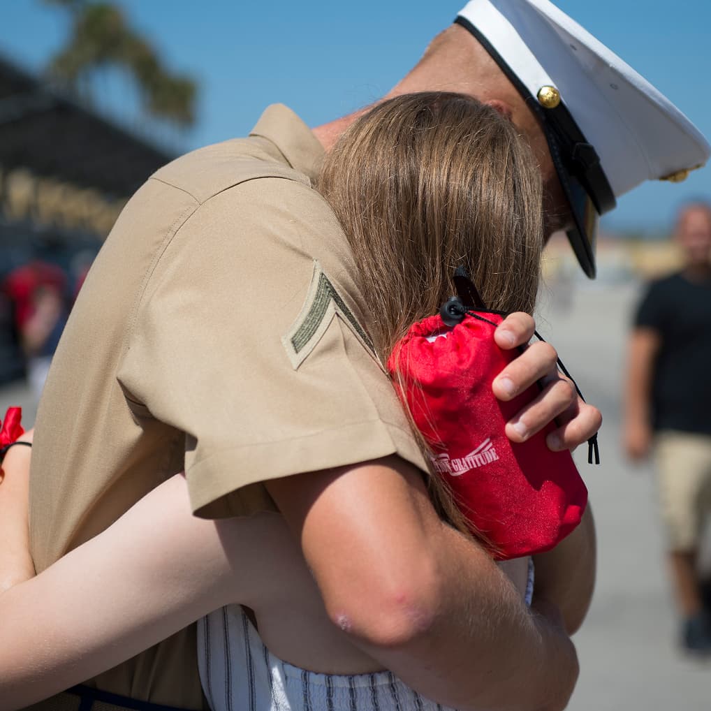 A service member embracing a loved one